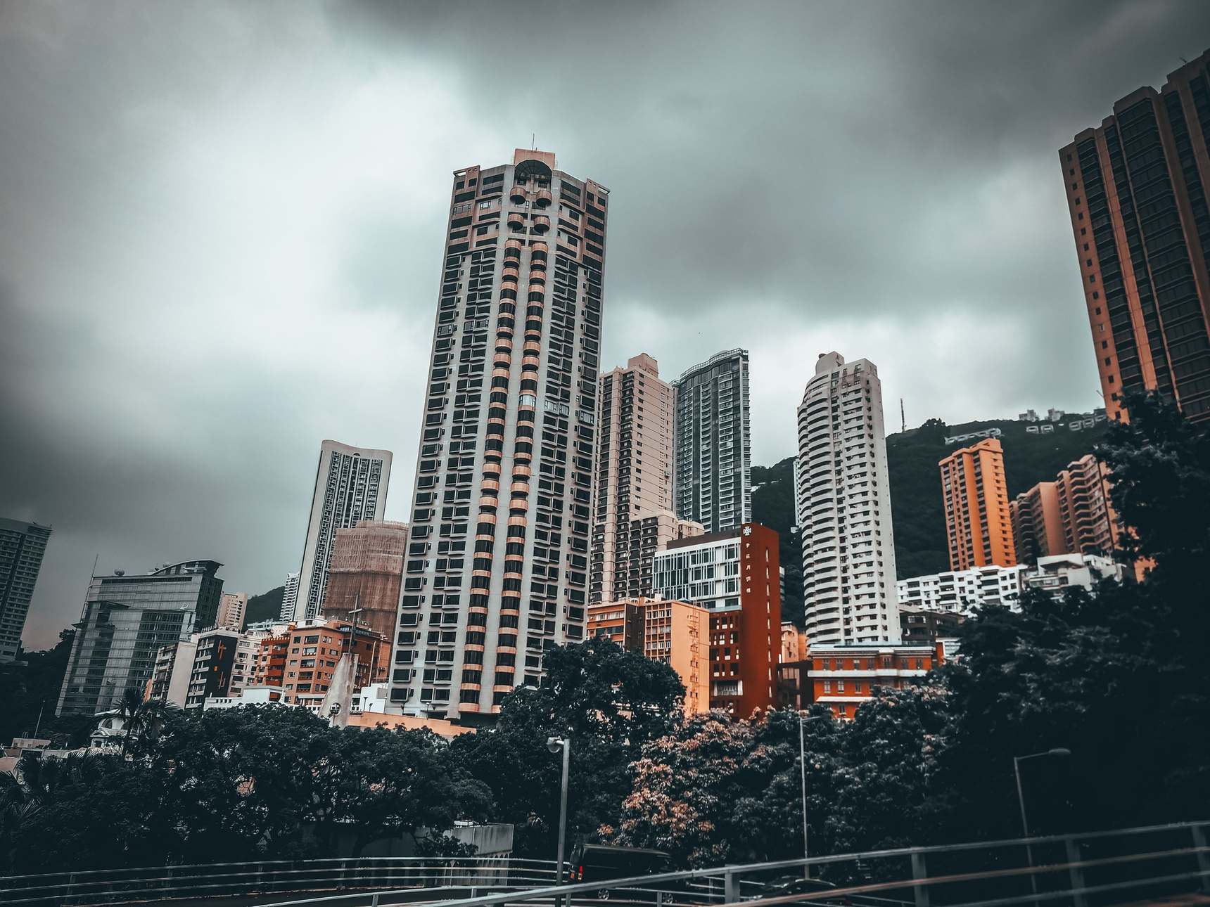 Modern office buildings along a city street under an overcast sky